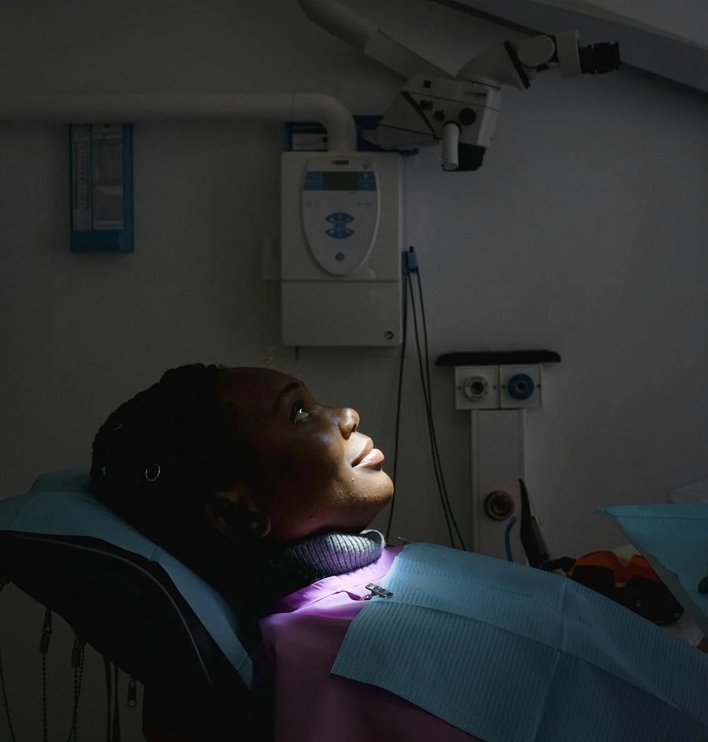 image of a patient on a dentists chair on her chest and back are consumable medical supplies and equipment